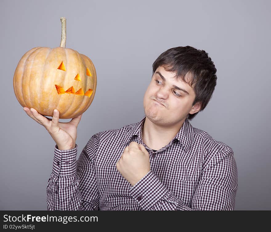 Funny men showing a pumpkin. Studio shot.