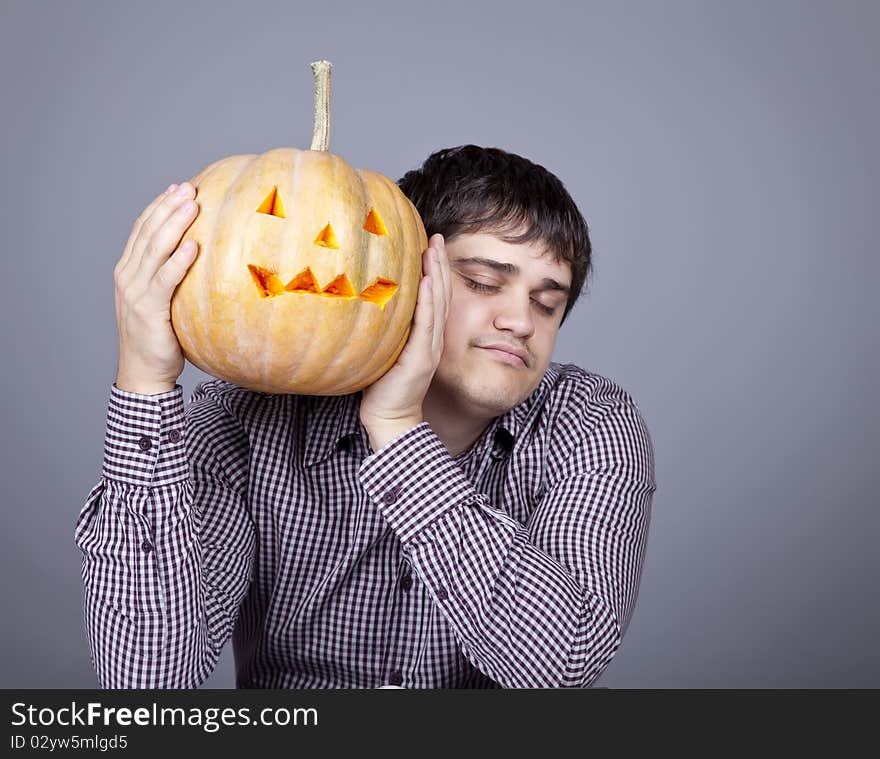 Funny men showing a pumpkin. Studio shot.