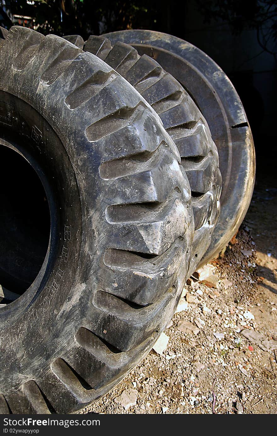 Old black tire in  ground. Old black tire in  ground