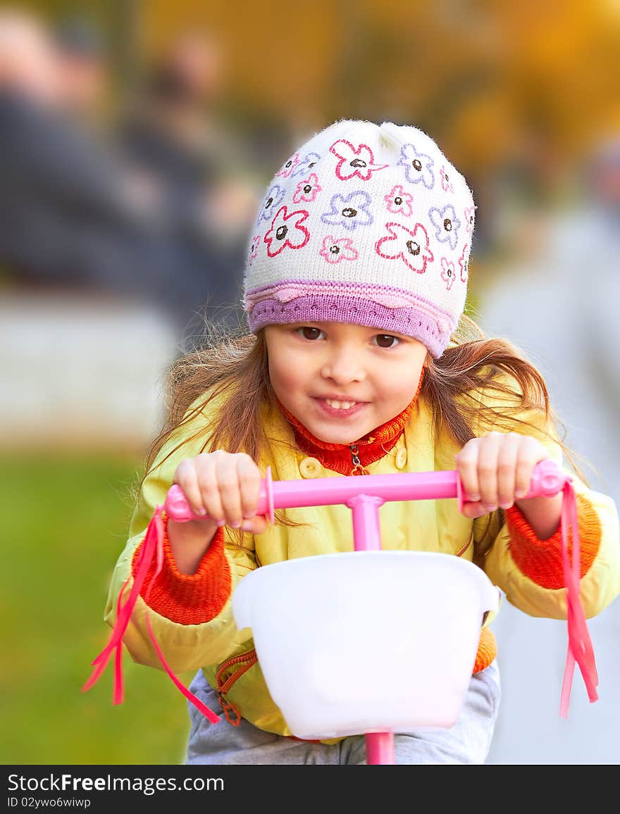 Little girl and her pink scooter