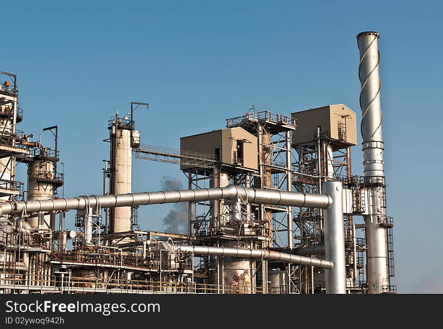 A petrochemical refinery plant with cooling towers and pipes.