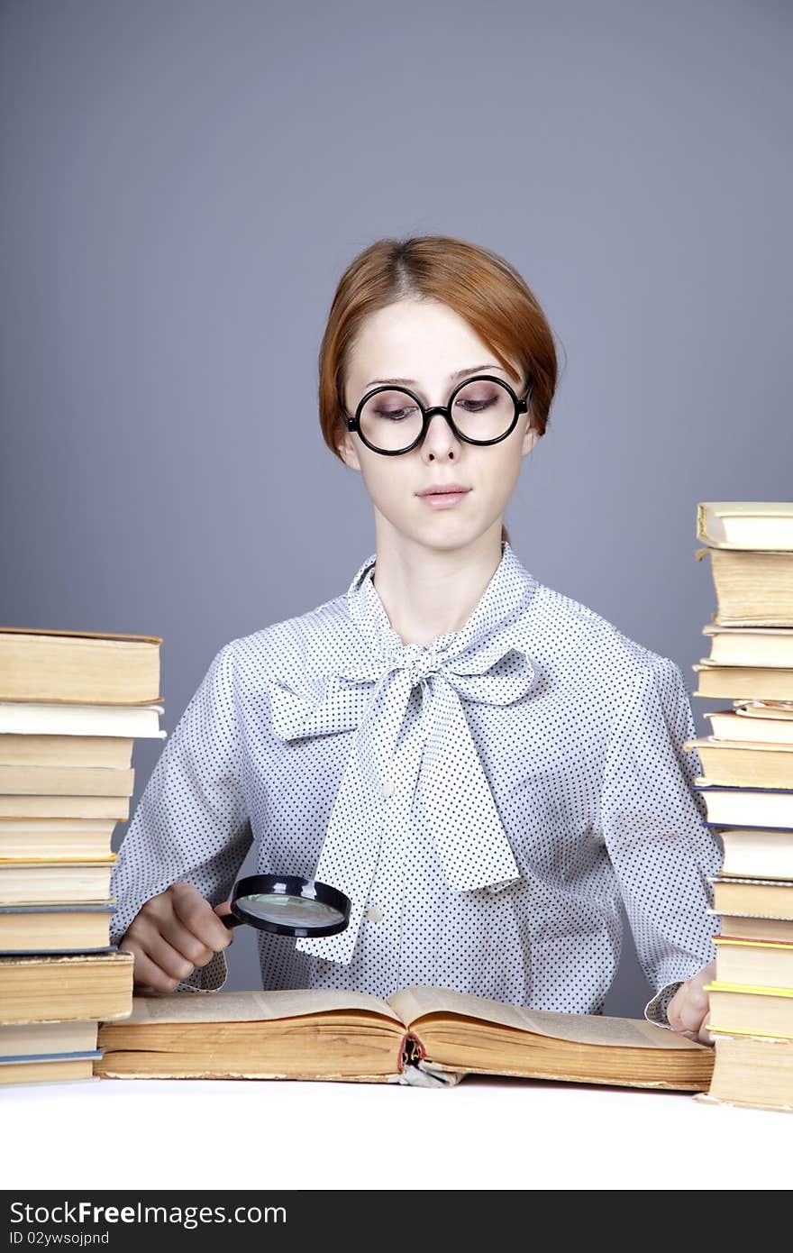 The Young Teacher In Glasses With Books.