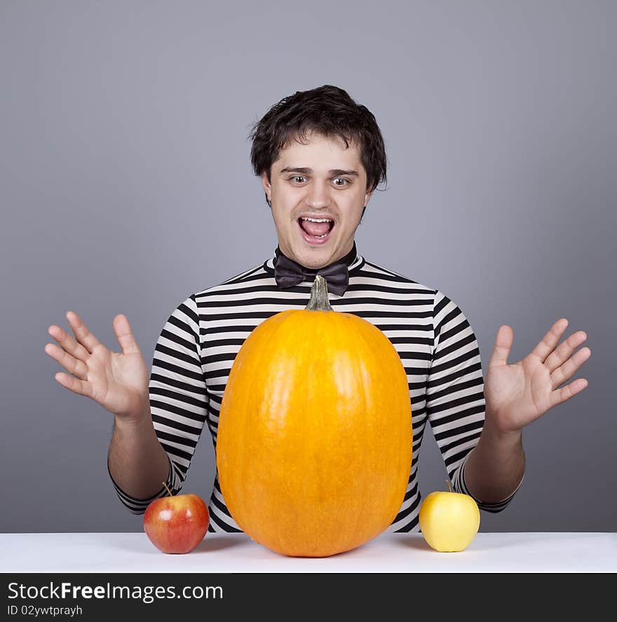 Funny men with two apples and one pumpkin. Studio shot.