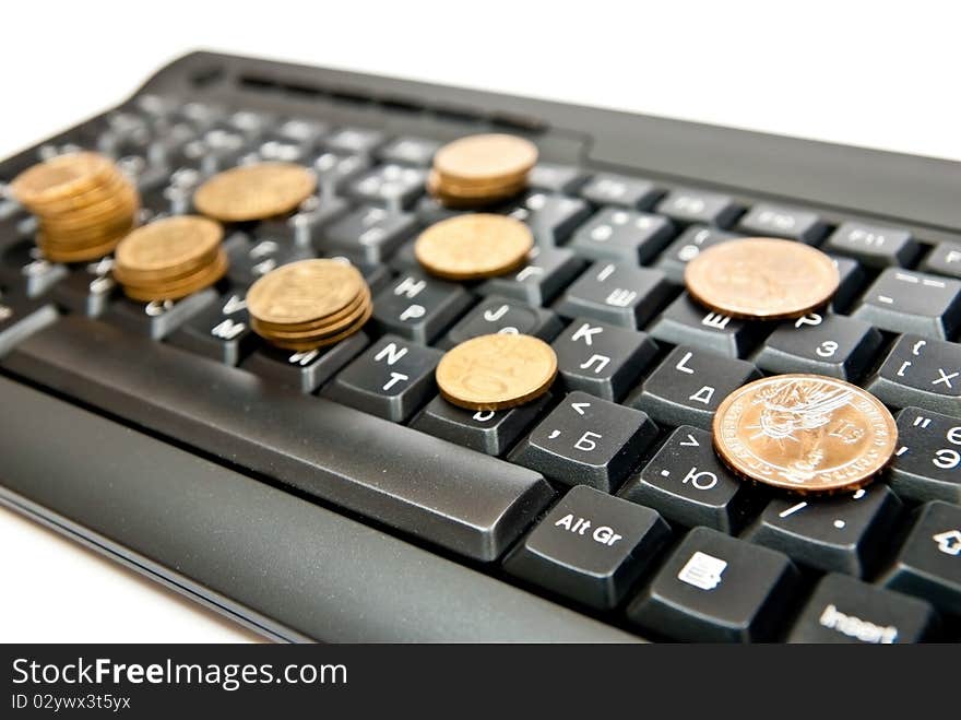 Heap of yellow coins on black keyboard. Heap of yellow coins on black keyboard