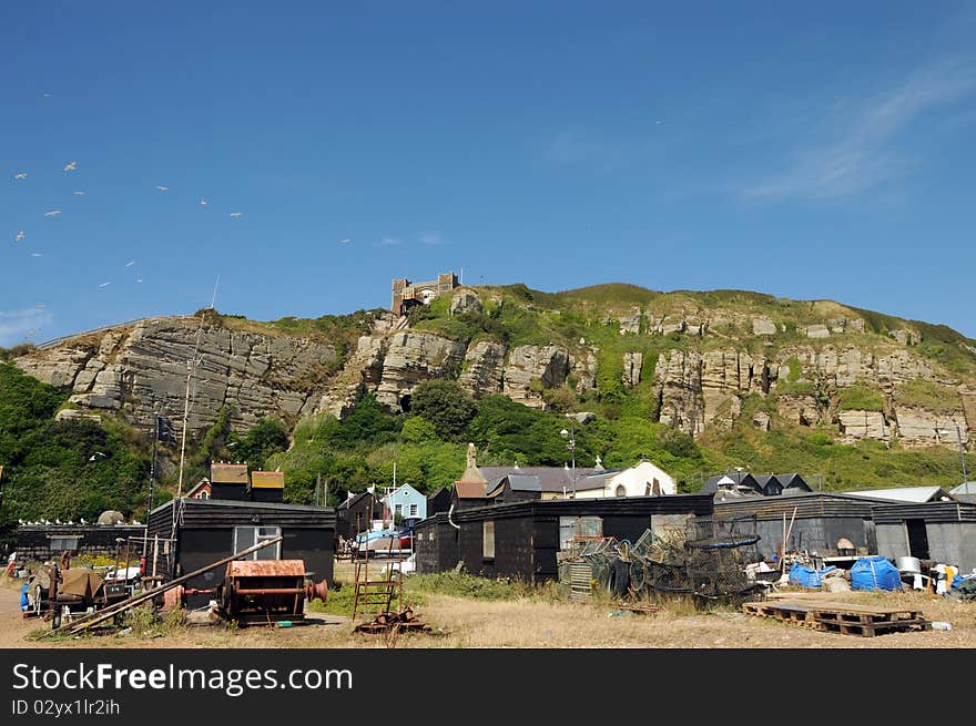 Fishing huts and boats moored on beach beneath East Hill, Hastings. Fishing huts and boats moored on beach beneath East Hill, Hastings