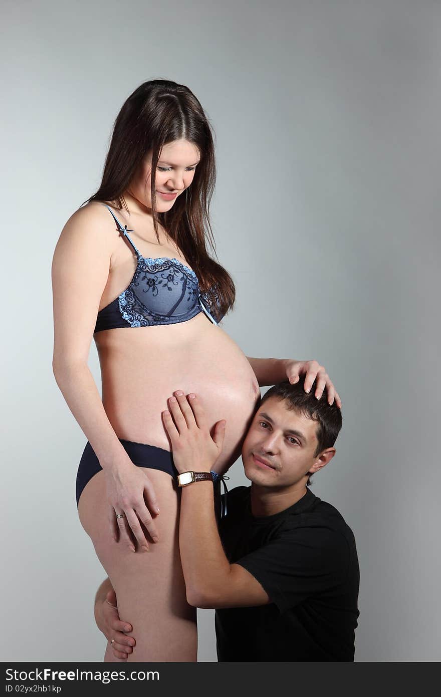 Pregnant Woman And Her Husband Embrace