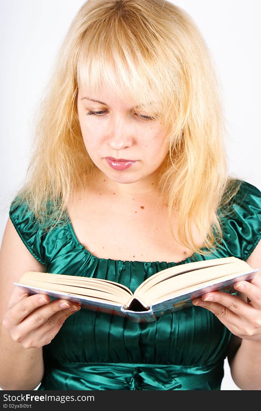 Blond girl reads big book, isolated on white background