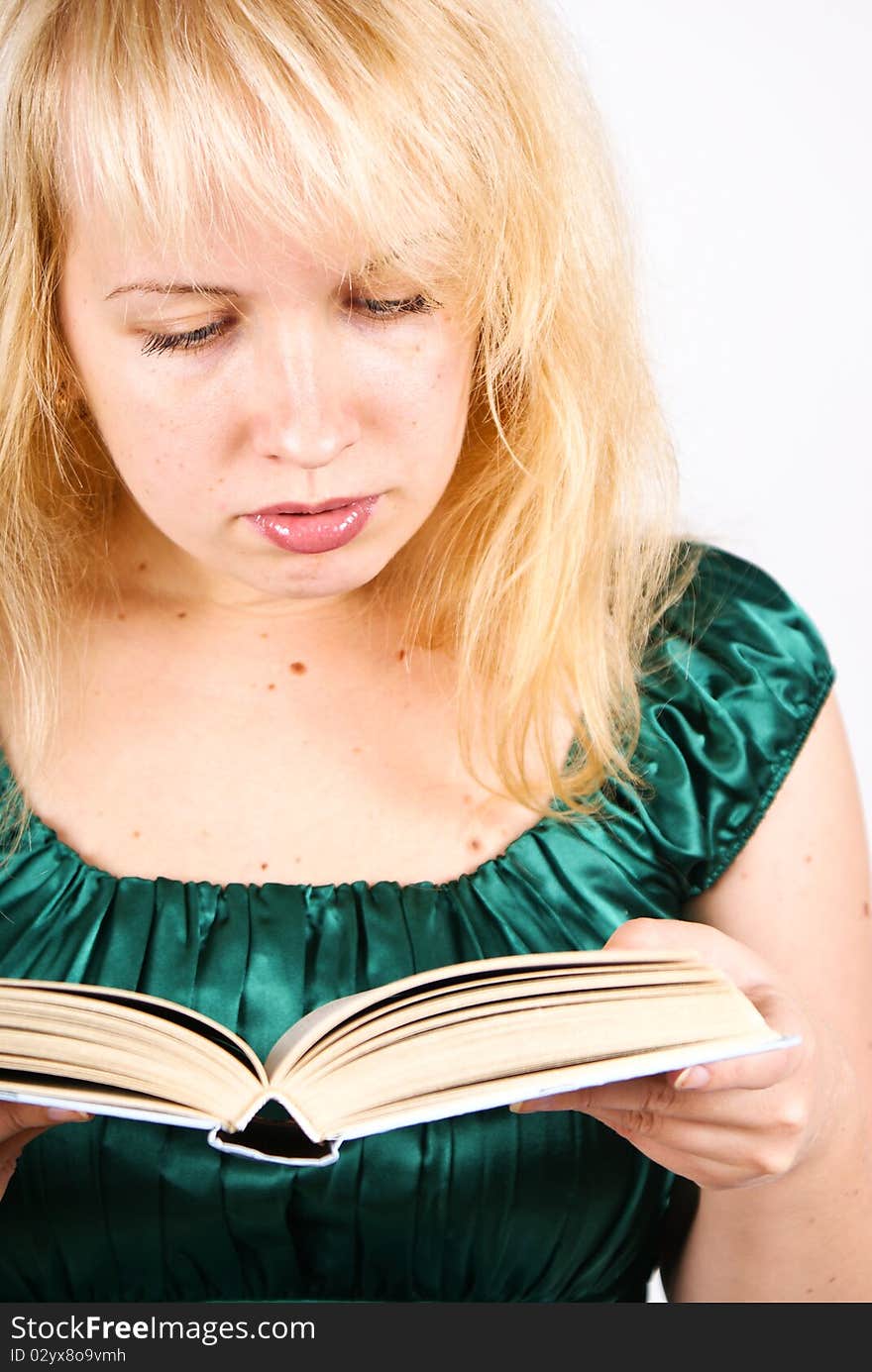 Blond girl reads big book, isolated on white background