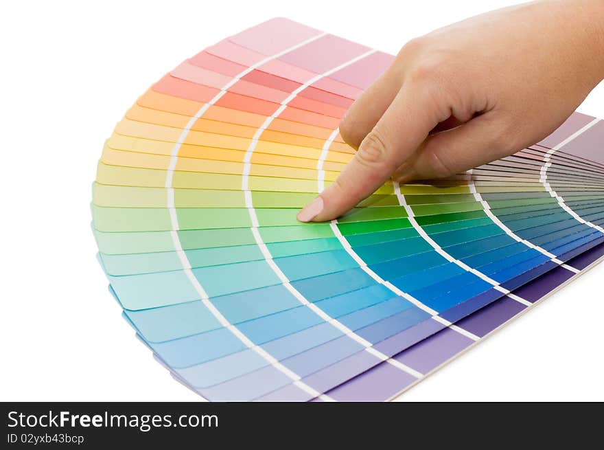 Woman hand pointing to a sample color chart close up