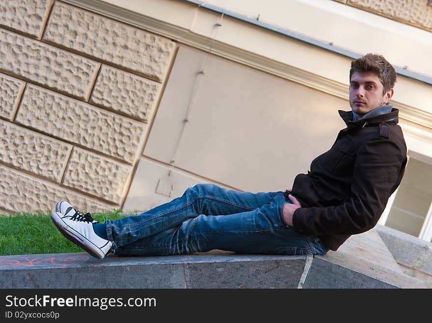 Young man sitting on slope steps