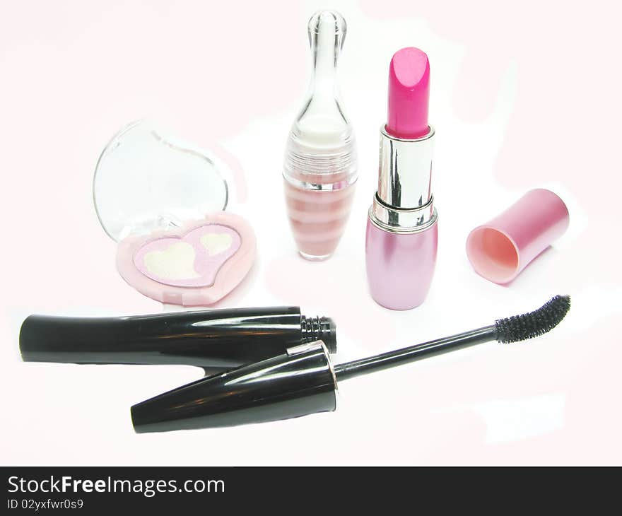 Pink lipstick eye shadows and black mascara cosmetic set. Pink lipstick eye shadows and black mascara cosmetic set