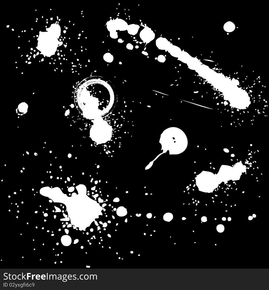 White ink splashes on black background