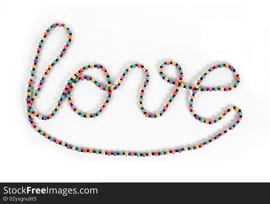 Love writing symbol made of colorful necklace. Love writing symbol made of colorful necklace