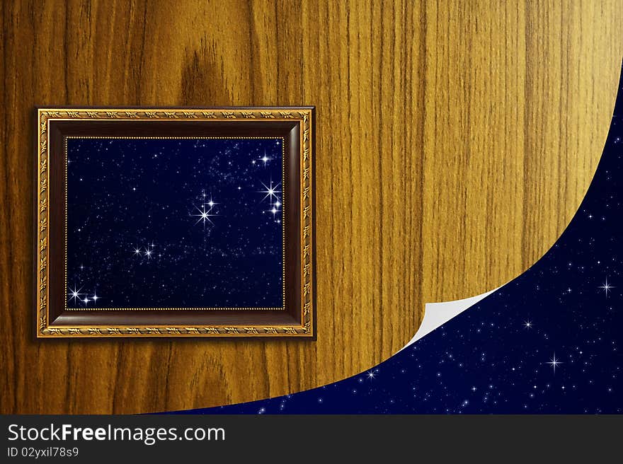 A photo of a wooden picture frame with the night sky setting inside