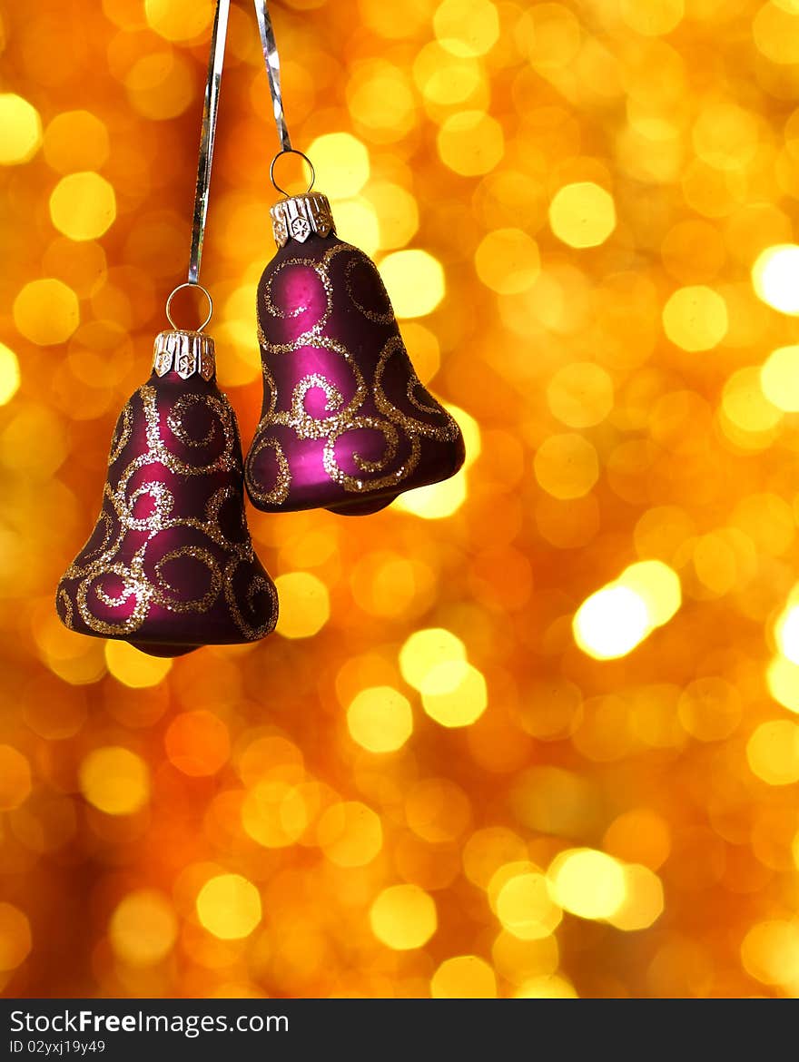 Christmas bells against gold blurred background