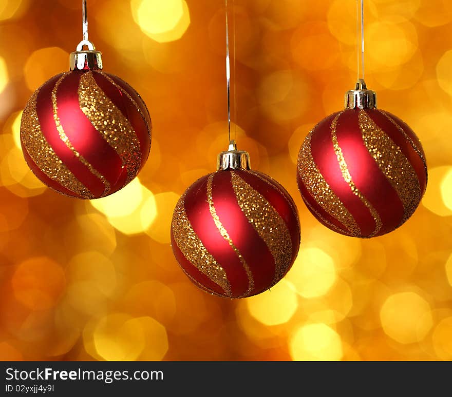 Red Christmas balls against gold background