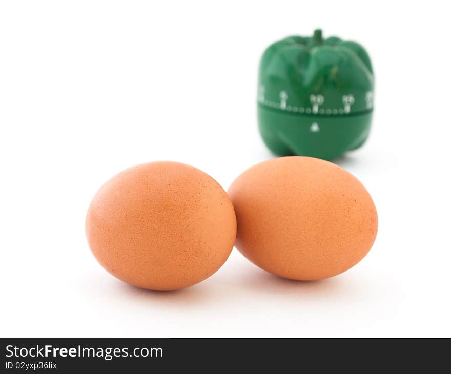 Concept of boiling eggs with eggs and green timer on white background