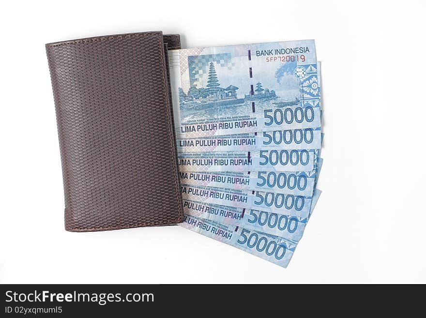 Still life photo of wallet and money over white background