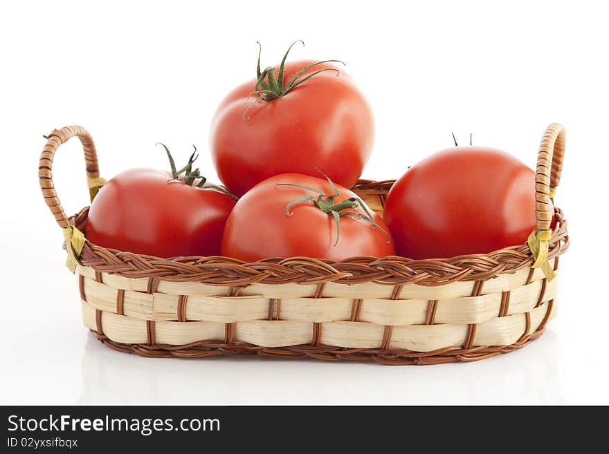 Ripe tomatoes in the woven basket