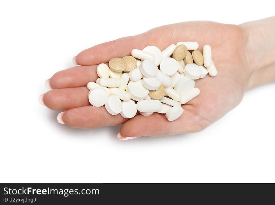 Beautiful woman hand with perfect manicure holding many medical pills. isolated on white background. Beautiful woman hand with perfect manicure holding many medical pills. isolated on white background