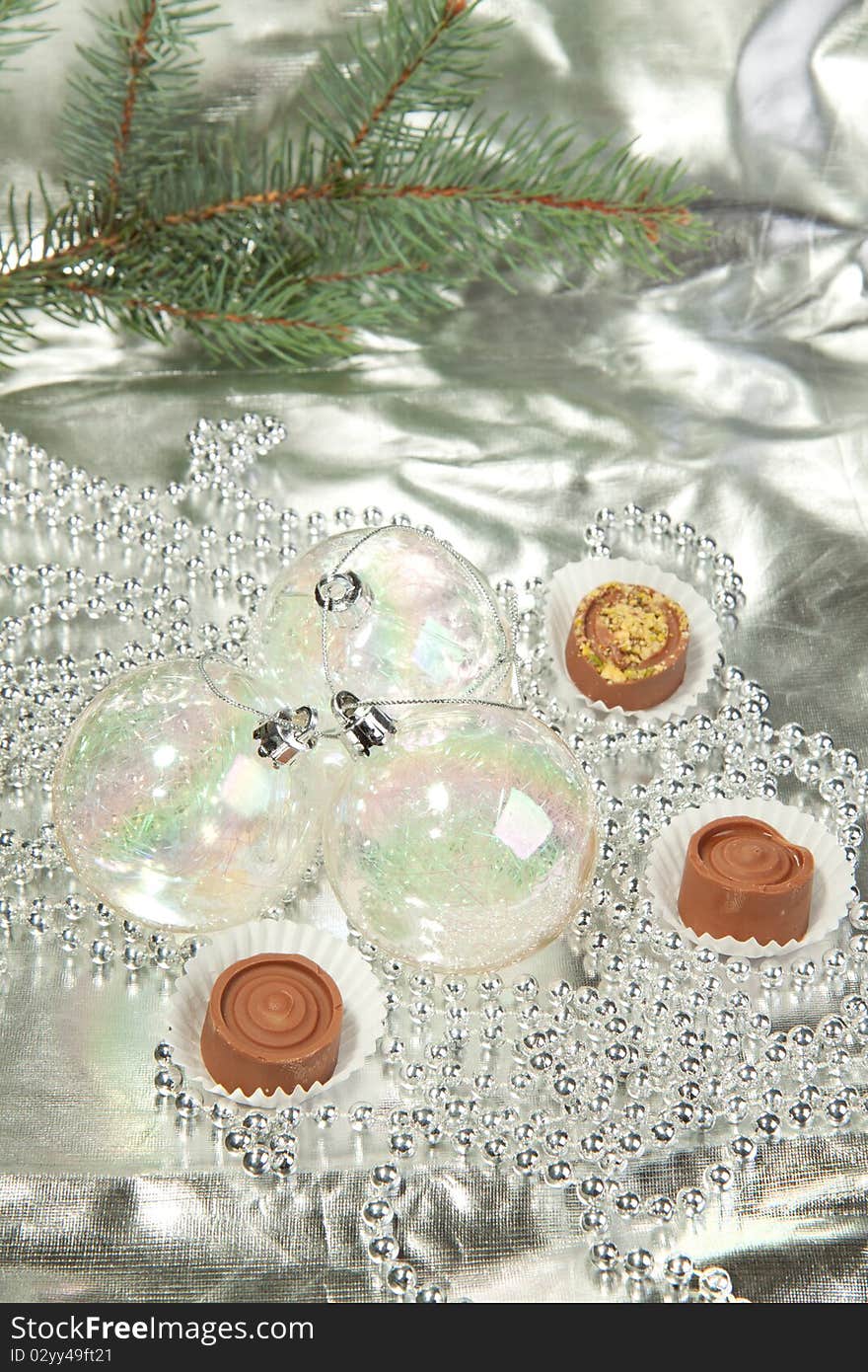 Transparent christmas balls with a homemade chocolate on a silver. Transparent christmas balls with a homemade chocolate on a silver