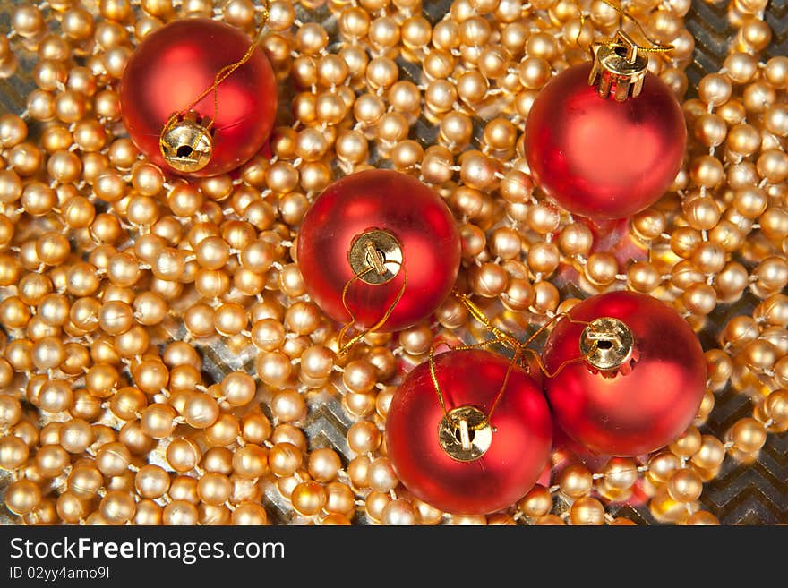 Red christmas balls on the golden beads