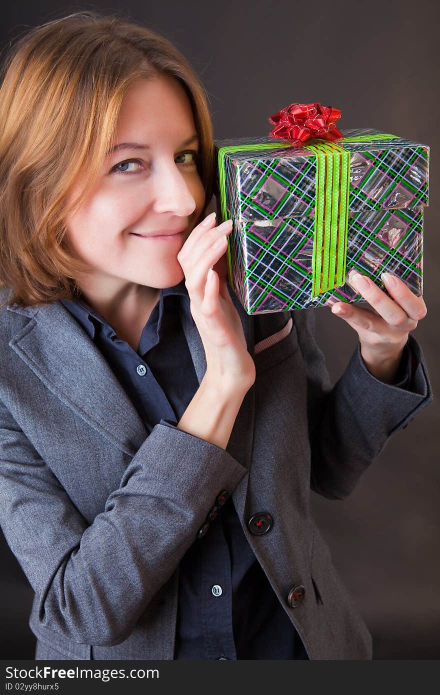 Girl in a business suit with a gift in a hands