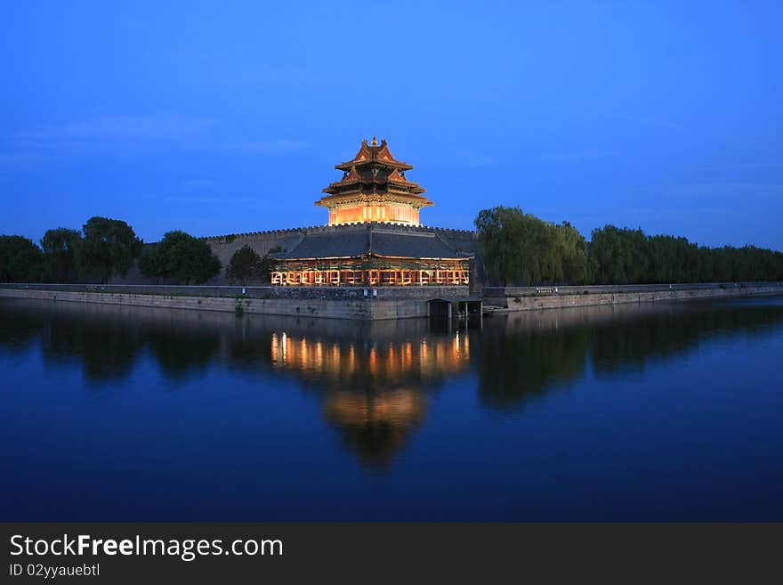 One of the turrets at the corner of Forbidden City in the dusk