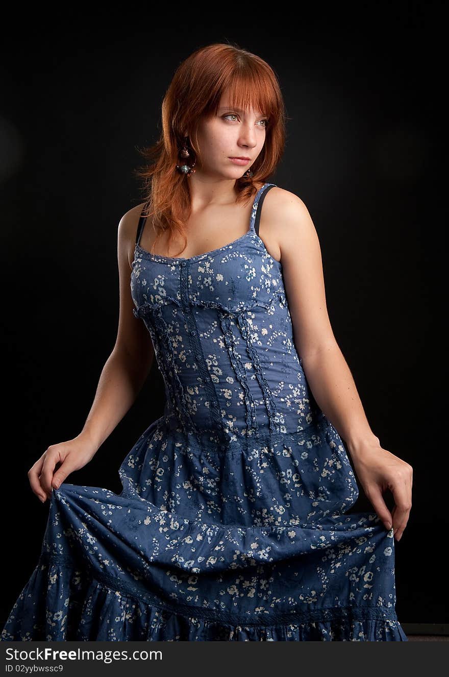 Sexy woman in blue dress in the dark