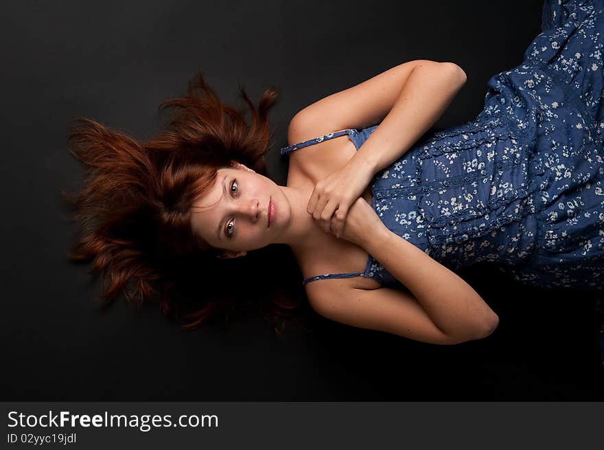 A girl lying on the floor in the dark