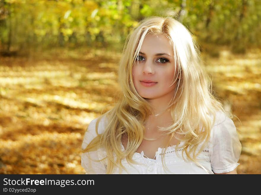 Young girl on autumn forest background