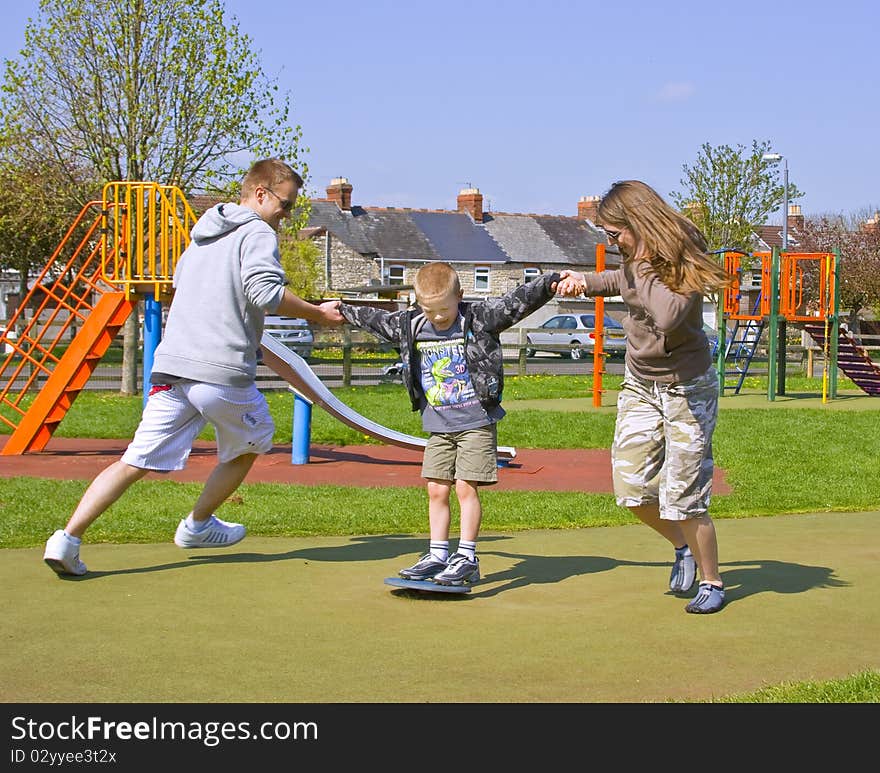 A young family play together in the park