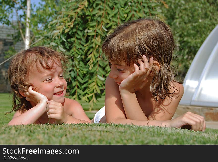 Two little girls playing in garden. Two little girls playing in garden