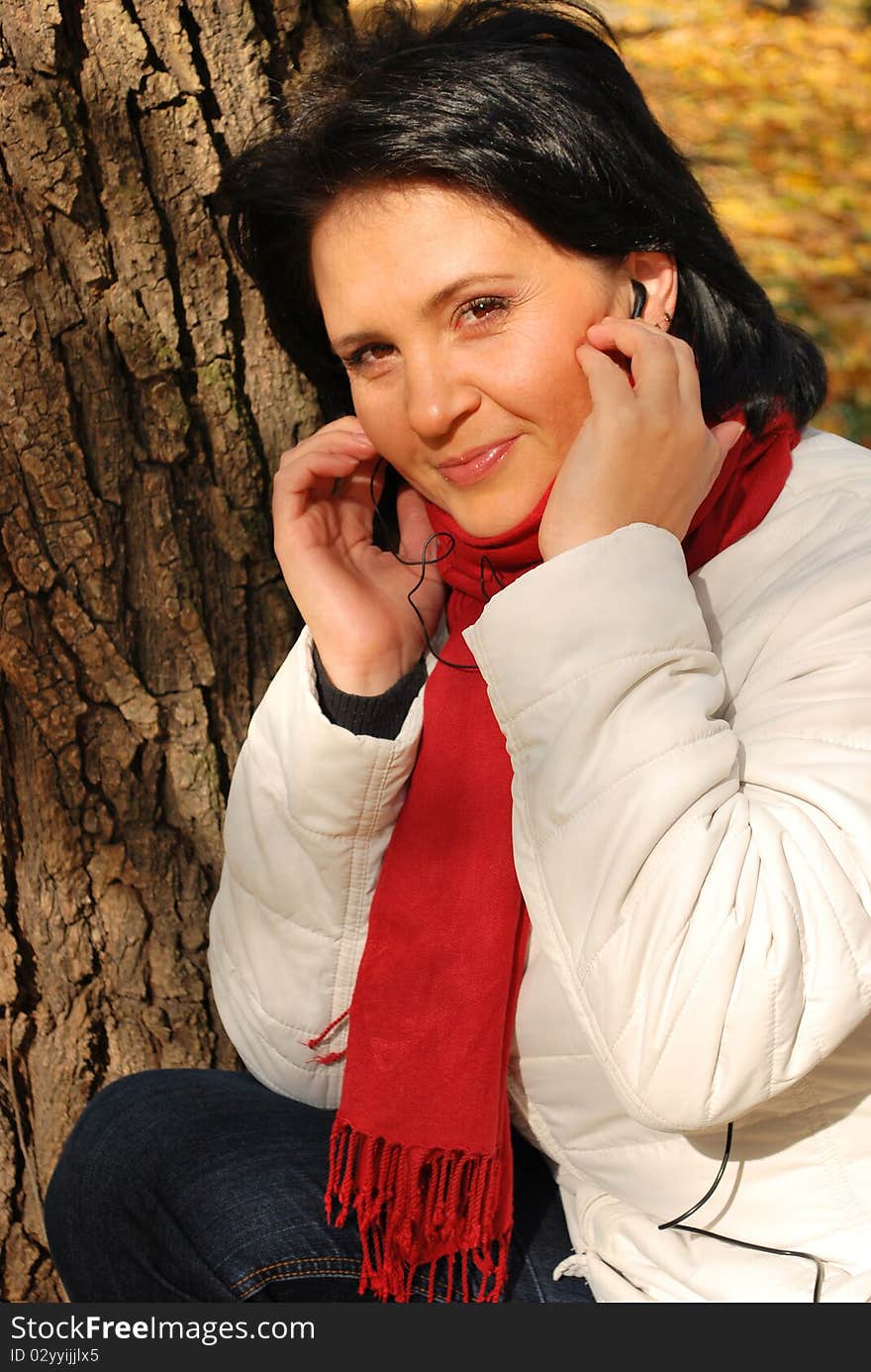 Young woman listening to the music outside. Young woman listening to the music outside