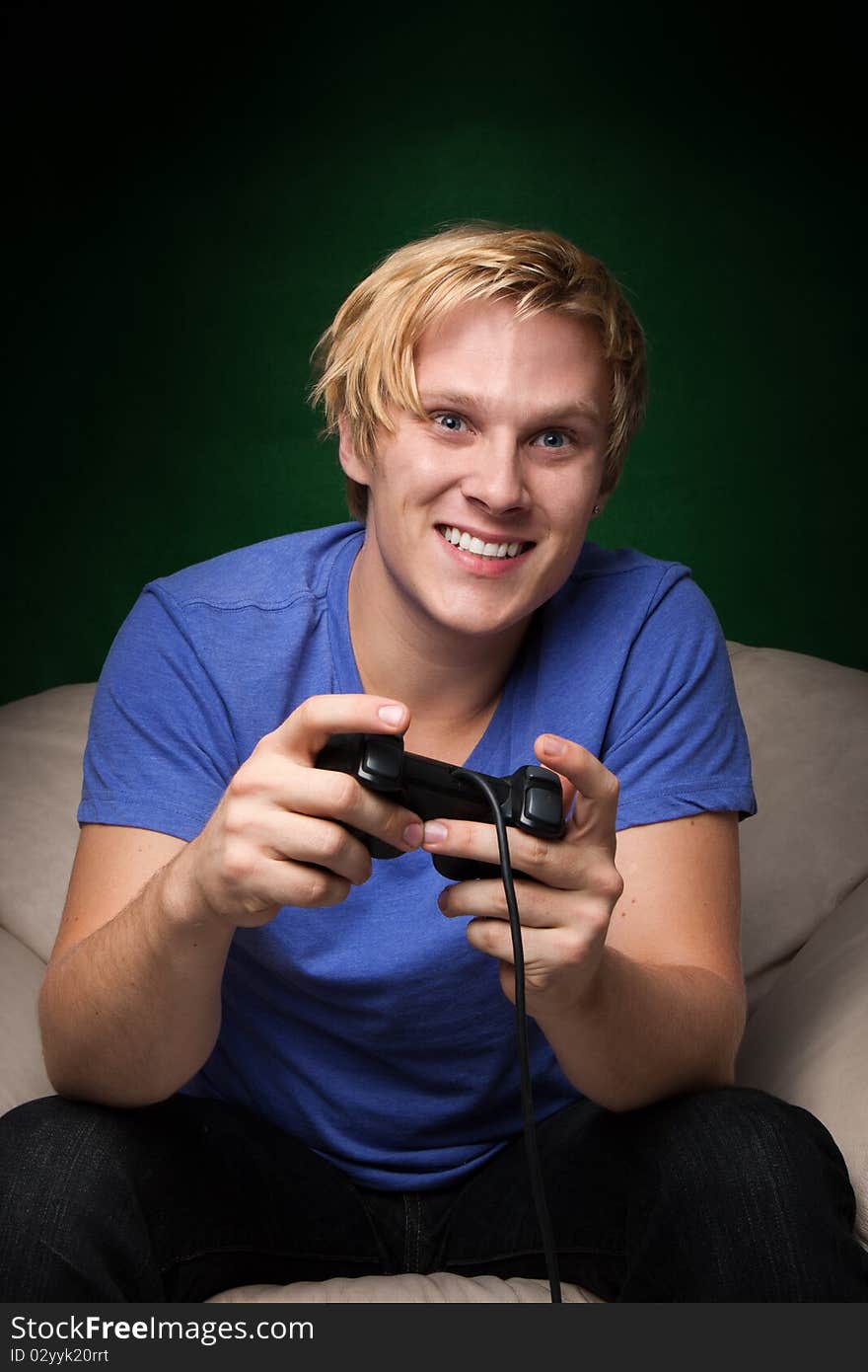 Smiling young man playing video games