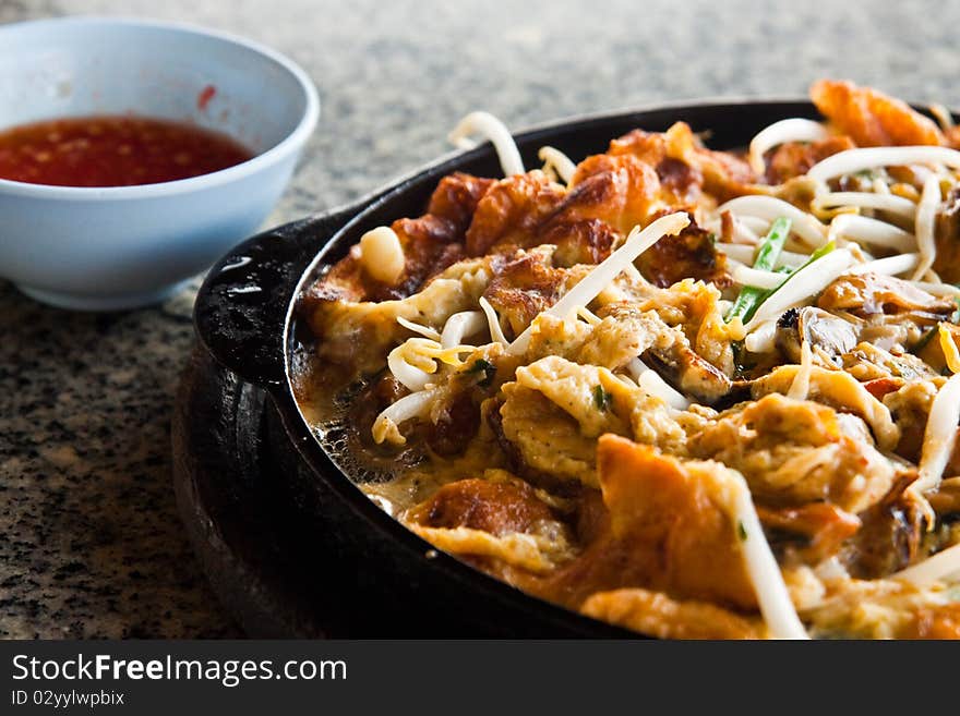 The oyster fried in hotplate. The oyster fried in hotplate