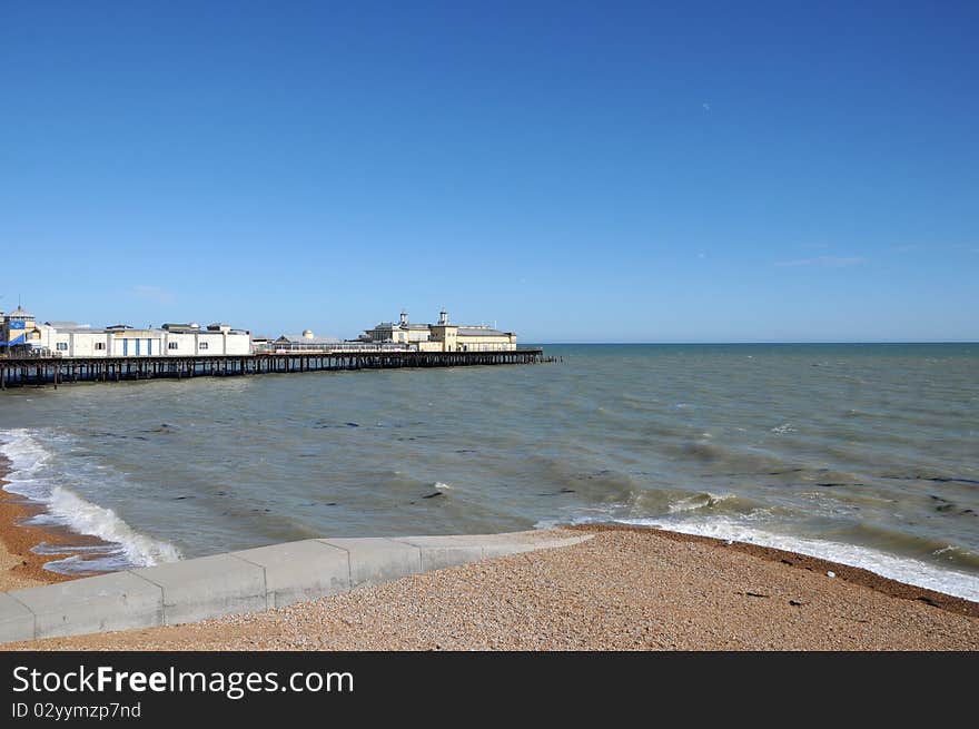 Shingly beach and waves, looking out to Hastings pier, Sussex