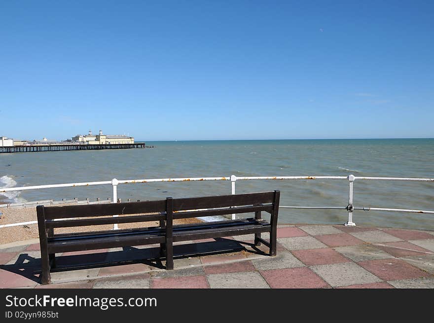 Benches on the esplanade look out to Hastings pier, Sussex