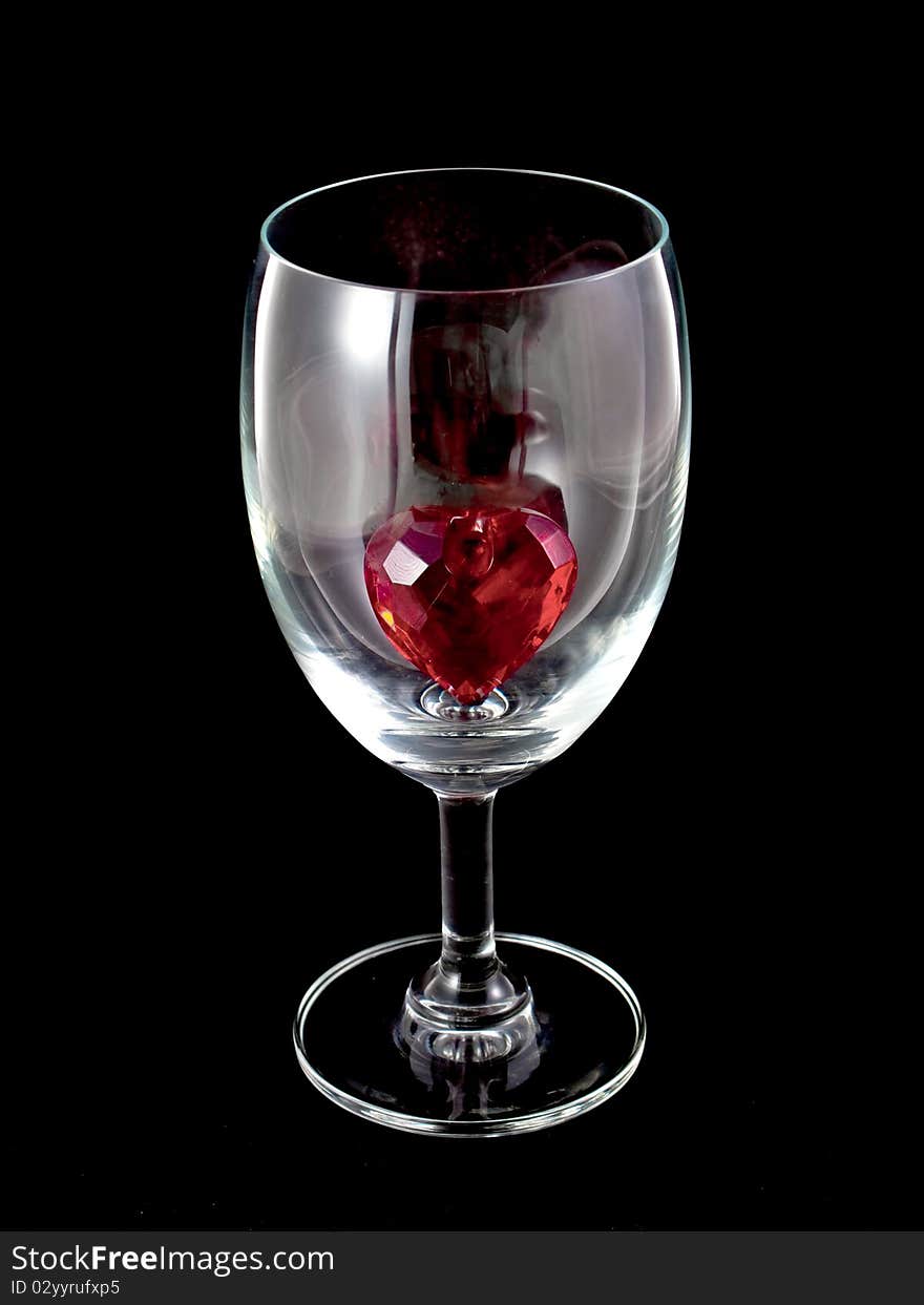 Hearts in a wine glass isolated on black background. Hearts in a wine glass isolated on black background