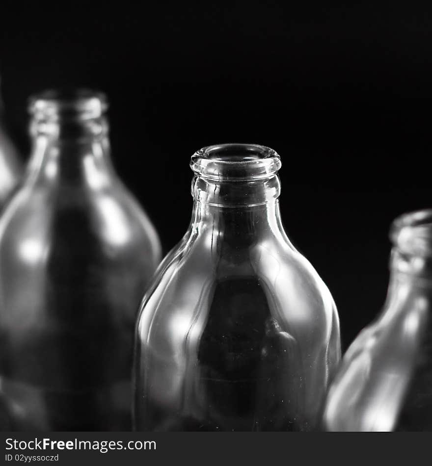 Empty bottles collection, colorless, isolated on black background