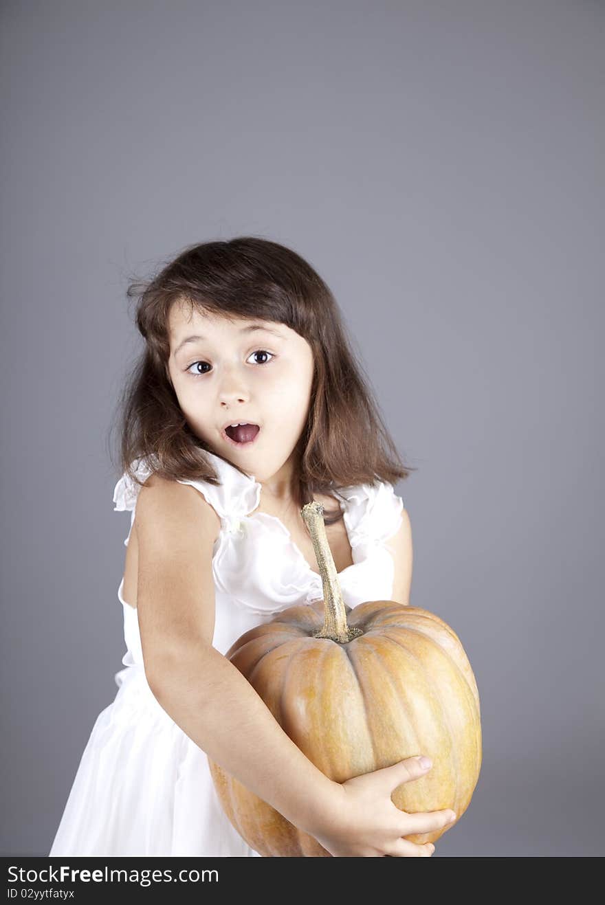 Young Girl In Dress With Pumpkin.