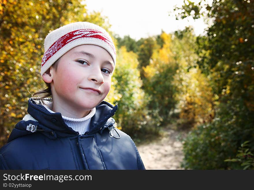 Portrait of a boy with a cheerful expression on his face.