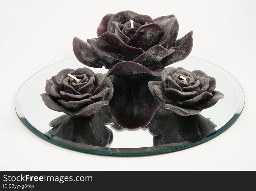 Black Candles in the shape of a flower on a white background. Black Candles in the shape of a flower on a white background