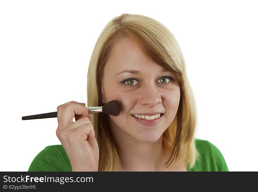 Attractive young woman applying blusher - isolated on white. Attractive young woman applying blusher - isolated on white