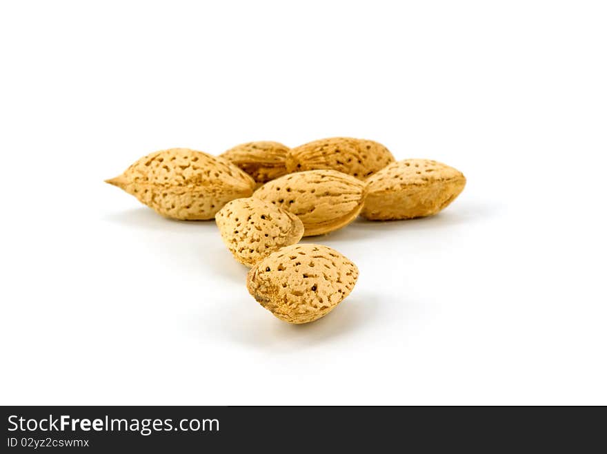 Heap of almonds on white background