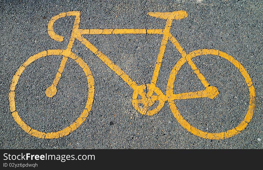 A yellow bicycle sign in city park