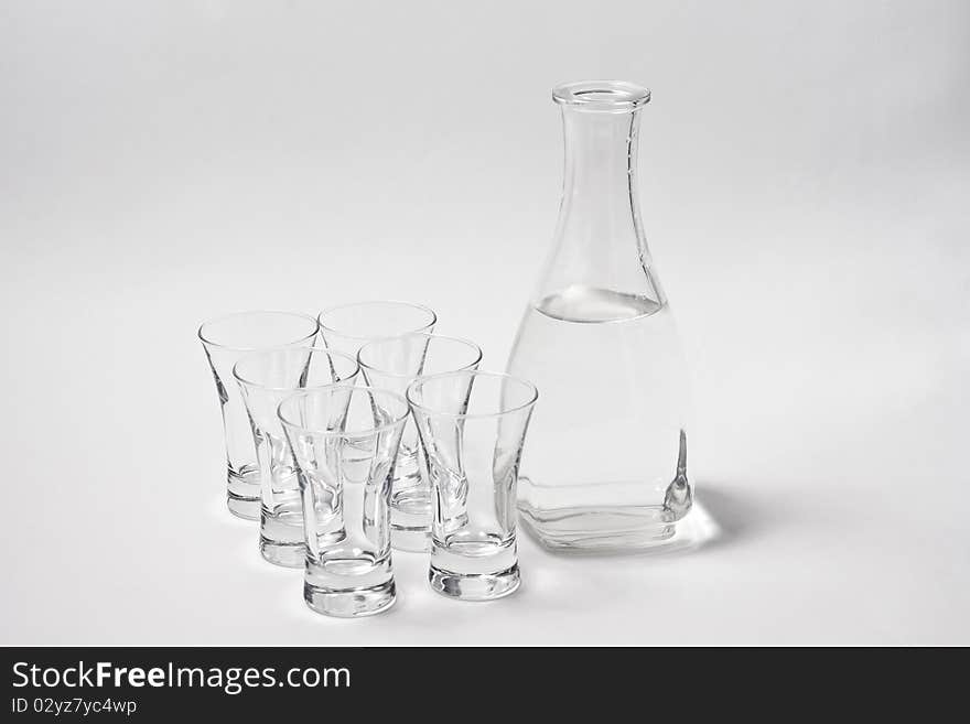 Decanter whith water and six glass on white background