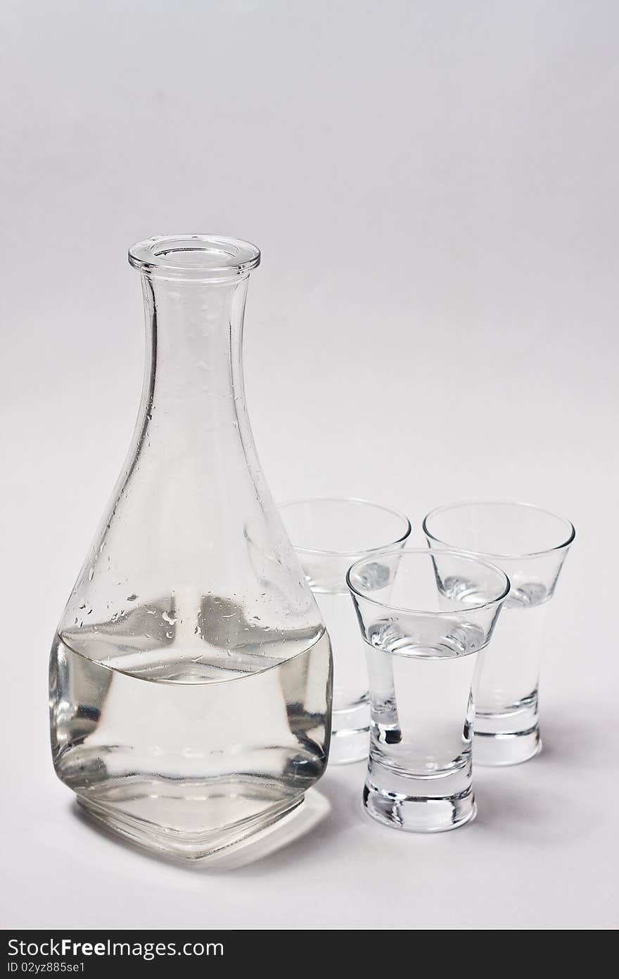 Decanter whith water and 3 glass on white background