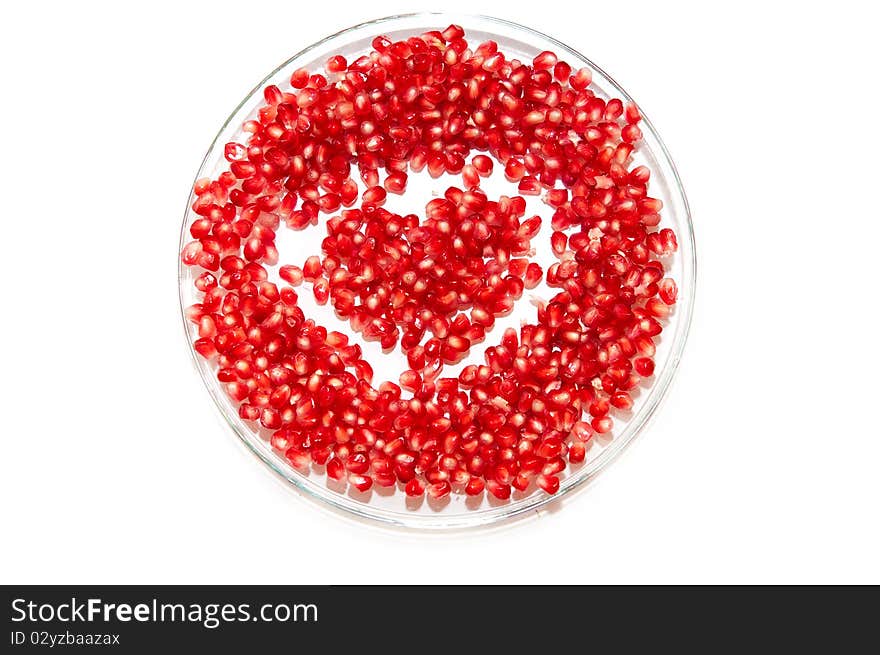 Heart made by pomegranate seeds on the plate. Heart made by pomegranate seeds on the plate