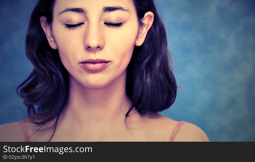 Beautiful woman portrait over blue background